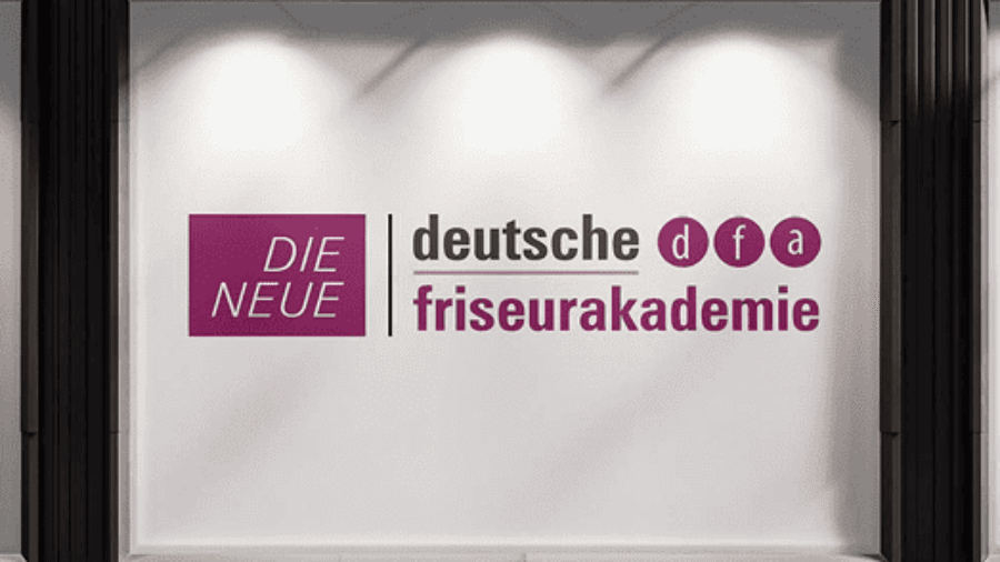 Logo der Deutschen Friseurakademie auf einem beleuchteten Hintergrund.